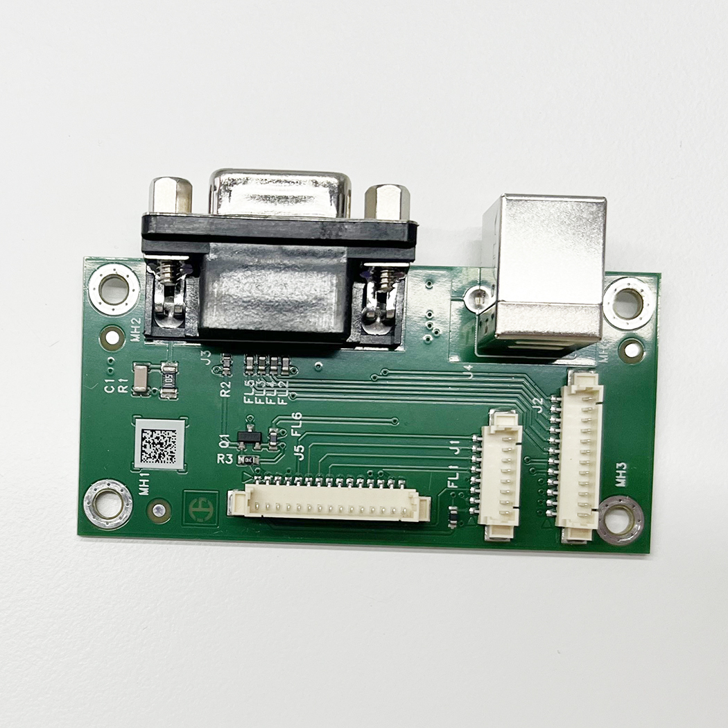 Zielona płyta interfejsu PCB OHAUS MB32 z portami RS-232 i USB — widok z przodu